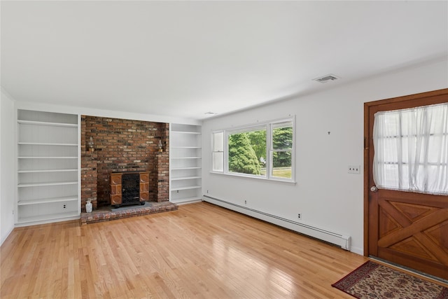 720 Midwood Rd, Cutchogue, NY 11935 - unfurnished living room with a baseboard heating unit, built in shelves, wood finished floors, and a fireplace