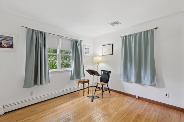 720 Midwood Rd, Cutchogue, NY 11935 - sitting room with baseboard heating and hardwood / wood-style flooring