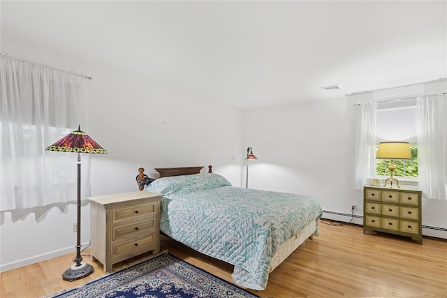 720 Midwood Rd, Cutchogue, NY 11935 - bedroom featuring baseboard heating and light wood-style floors