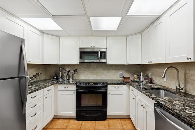 720 Midwood Rd, Cutchogue, NY 11935 - kitchen featuring stainless steel appliances, white cabinets, tasteful backsplash, and dark stone counters