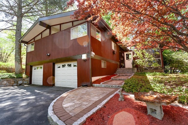 view of property exterior featuring driveway and a garage
