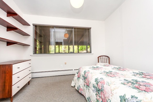 carpeted bedroom featuring a baseboard heating unit