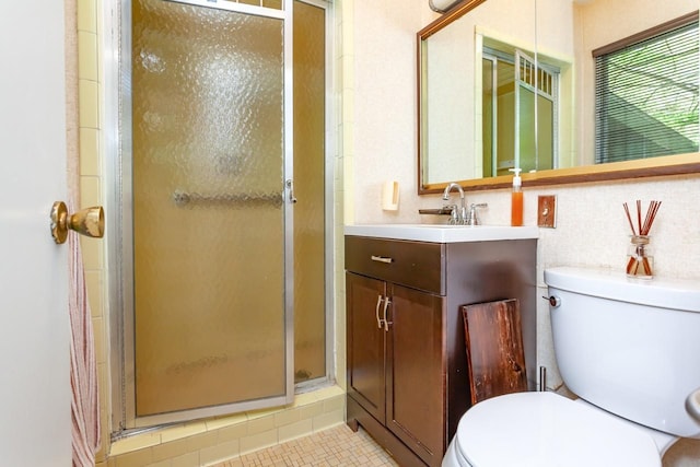 full bathroom featuring vanity, toilet, and a stall shower