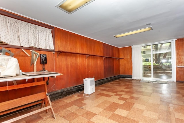 basement with wooden walls and light floors