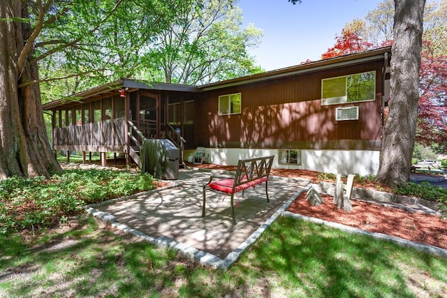 back of house featuring a patio and a sunroom