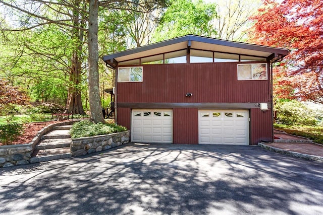 garage with aphalt driveway