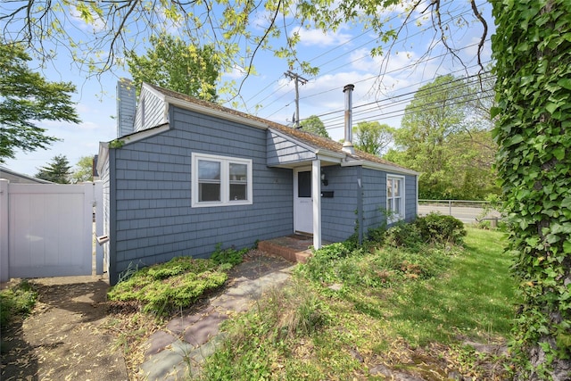 96 Pardee Ave, Islip, NY 11751 - back of house with a chimney, fence, and a gate