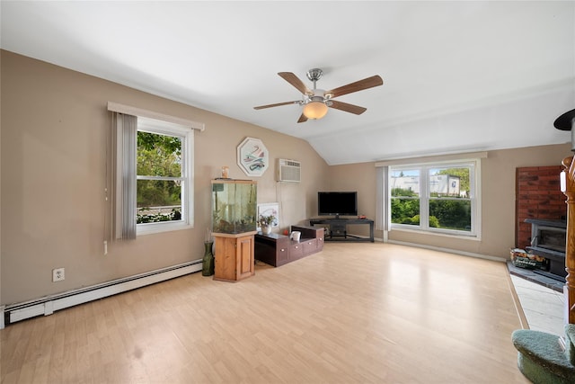 96 Pardee Ave, Islip, NY 11751 - living area with a baseboard radiator, ceiling fan, light wood finished floors, a wood stove, and vaulted ceiling