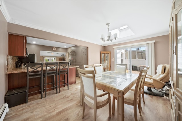 96 Pardee Ave, Islip, NY 11751 - dining space with crown molding, light wood-style floors, a chandelier, baseboard heating, and a skylight