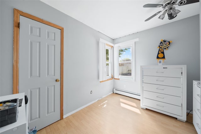 96 Pardee Ave, Islip, NY 11751 - bedroom featuring baseboard heating, light wood-style floors, a ceiling fan, and baseboards
