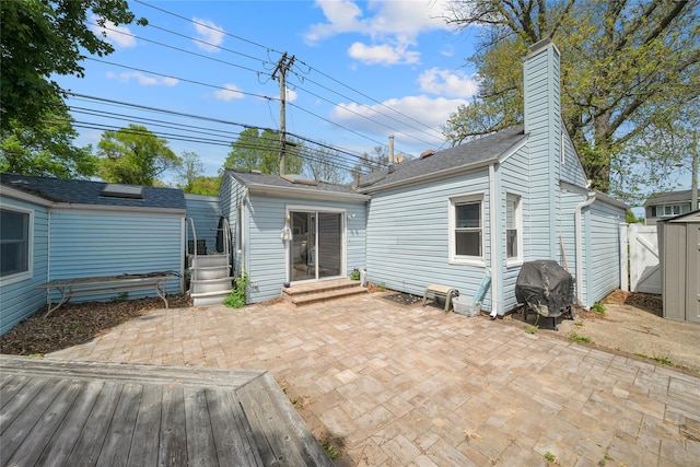 96 Pardee Ave, Islip, NY 11751 - rear view of house with a patio area, entry steps, a chimney, an outbuilding, and a shed