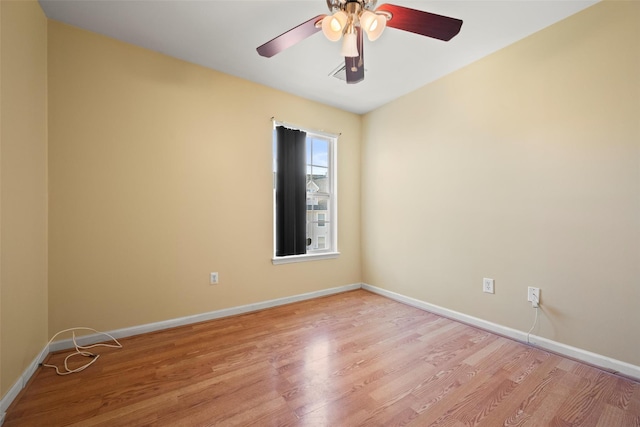 empty room featuring baseboards, ceiling fan, and light wood-type flooring