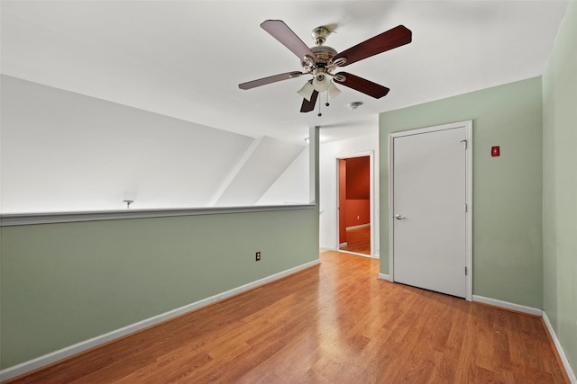 bonus room featuring ceiling fan, vaulted ceiling, baseboards, and light wood finished floors