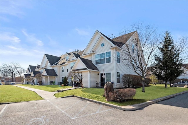 view of front of home with a front lawn and a residential view