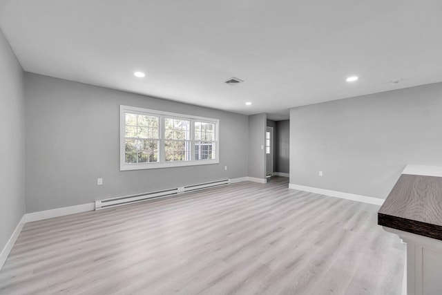 unfurnished living room with light wood-style flooring, recessed lighting, baseboards, a baseboard radiator, and visible vents