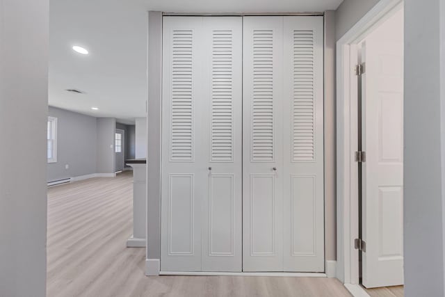 details with baseboards, a baseboard radiator, wood finished floors, and visible vents