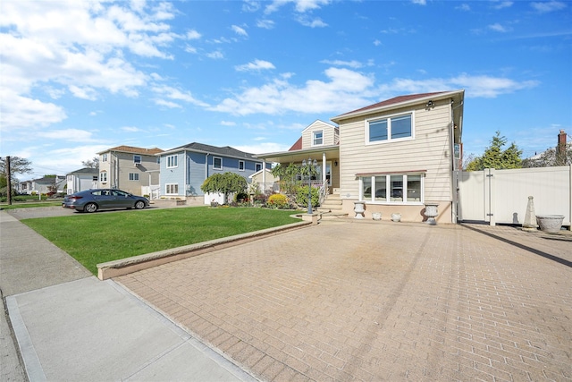 86 Jefferson Ave, Island Park, NY 11558 - split level home featuring a residential view, a gate, a front lawn, and fence