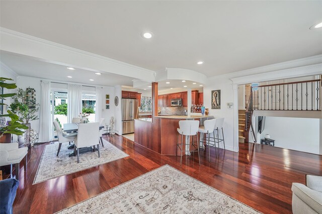 86 Jefferson Ave, Island Park, NY 11558 - kitchen featuring stainless steel appliances, dark wood finished floors, ornamental molding, and a peninsula