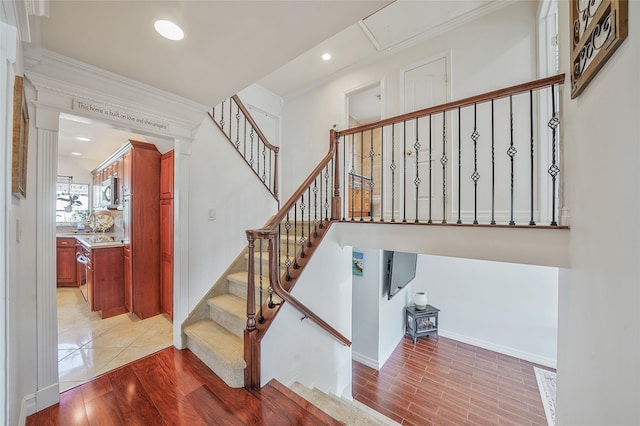 86 Jefferson Ave, Island Park, NY 11558 - stairway with crown molding, baseboards, recessed lighting, and wood finished floors