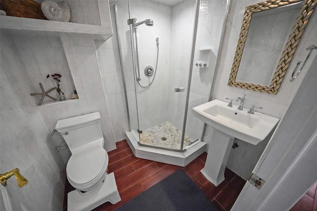 86 Jefferson Ave, Island Park, NY 11558 - bathroom featuring wood tiled floor, a shower stall, toilet, and tile walls