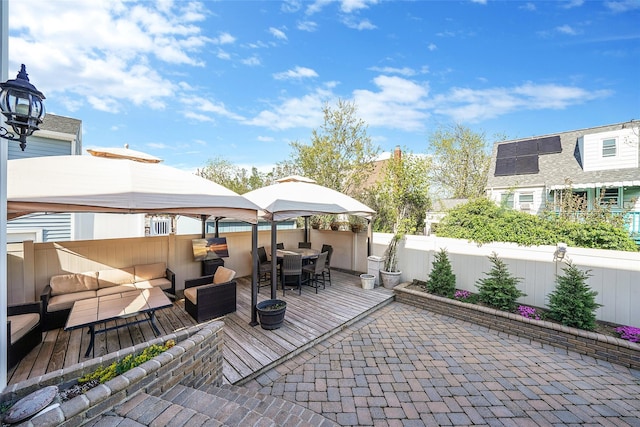 86 Jefferson Ave, Island Park, NY 11558 - view of patio with outdoor dining space, a gazebo, a wooden deck, outdoor lounge area, and a fenced backyard