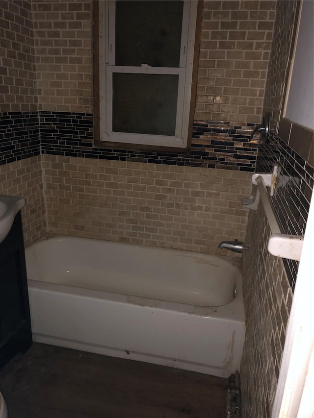 bathroom with tile walls and bathing tub / shower combination
