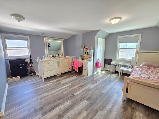 221-15 112th Ave, Queens Village, NY 11429 - bedroom featuring radiator, vaulted ceiling, wood finished floors, and baseboards