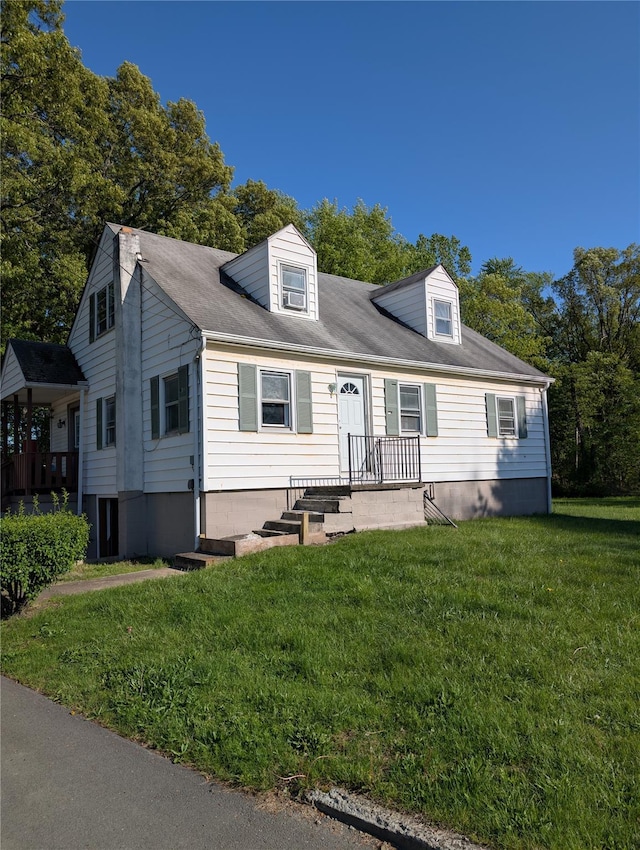 cape cod house with a front yard
