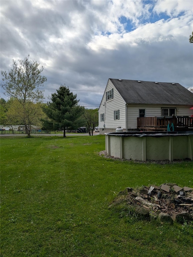 view of grassy yard with a covered pool