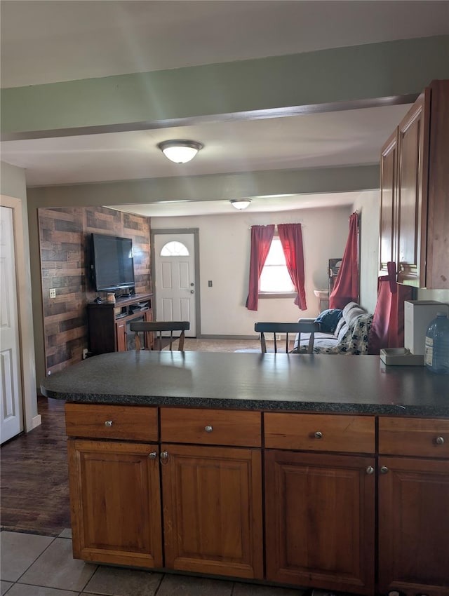 kitchen featuring dark countertops, brown cabinetry, and tile patterned flooring