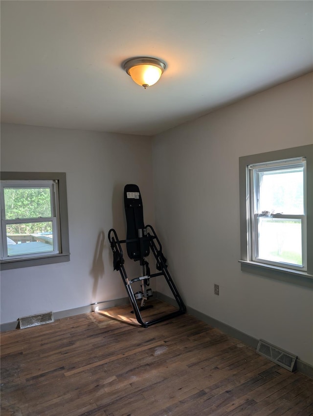 workout area with wood finished floors and baseboards