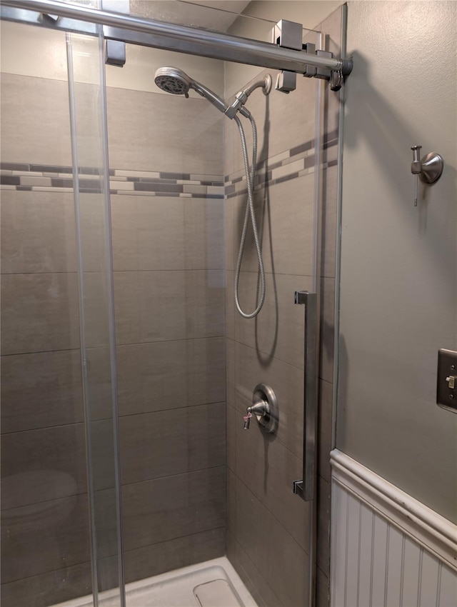 full bath featuring a shower stall