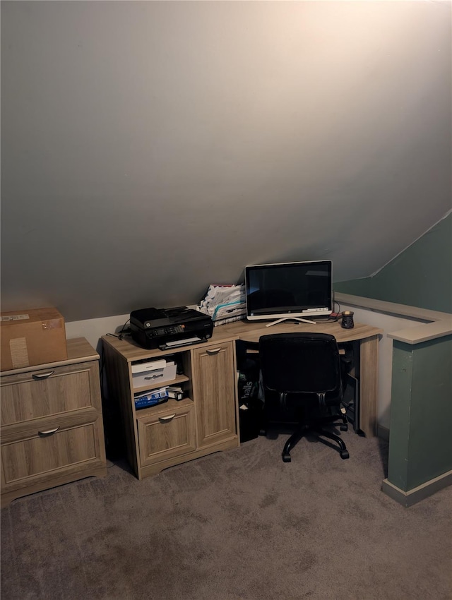 carpeted home office featuring lofted ceiling