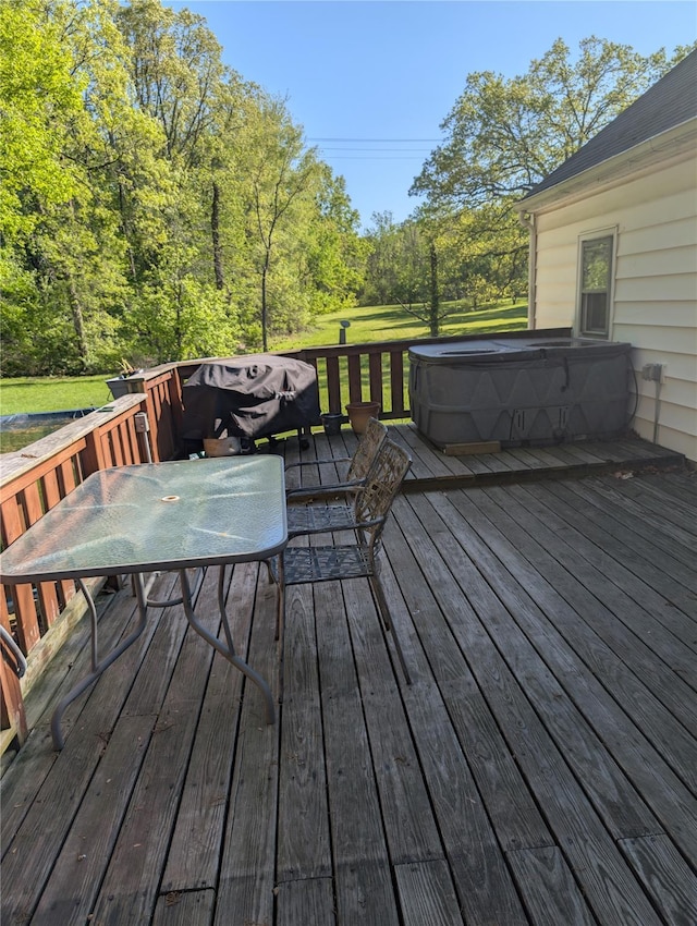 deck with a covered hot tub and outdoor dining space