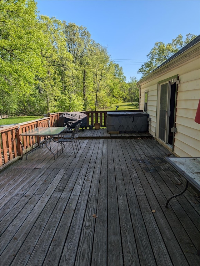 wooden terrace featuring a hot tub
