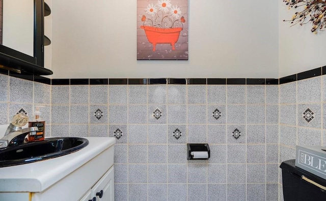 bathroom featuring vanity and tile walls