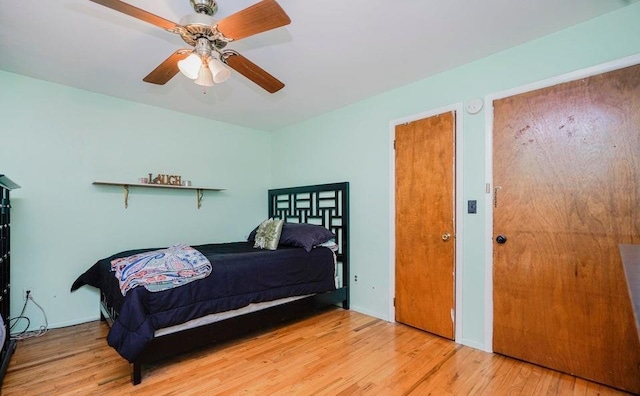 bedroom with ceiling fan and wood finished floors