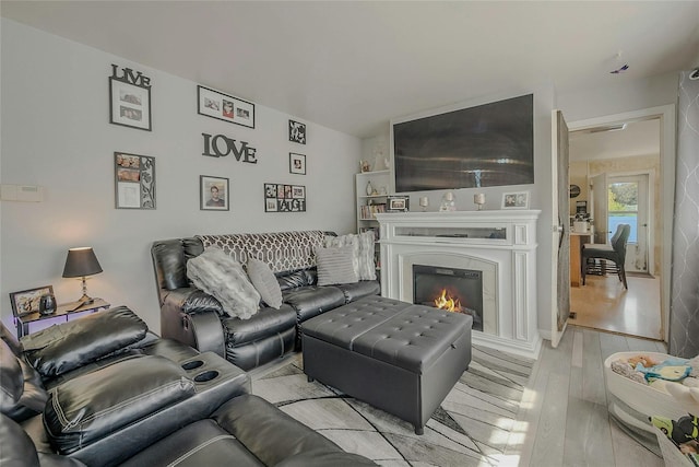 203 N Coleman Rd, Centereach, NY 11720 - living area with wood finished floors and a warm lit fireplace