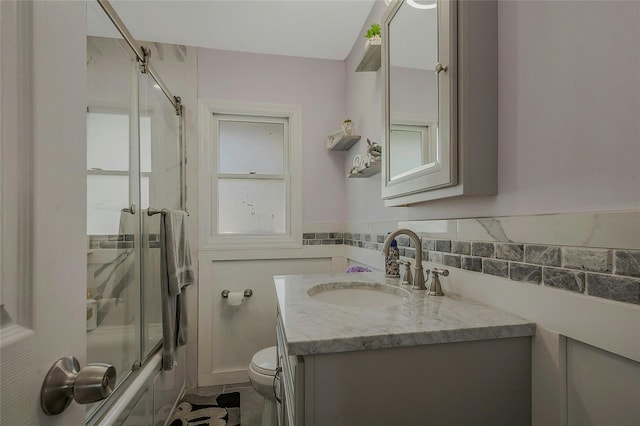 203 N Coleman Rd, Centereach, NY 11720 - full bath featuring vanity, toilet, bath / shower combo with glass door, and tile patterned flooring