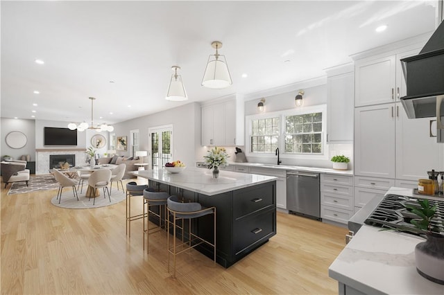 kitchen featuring white cabinets, open floor plan, appliances with stainless steel finishes, and a center island