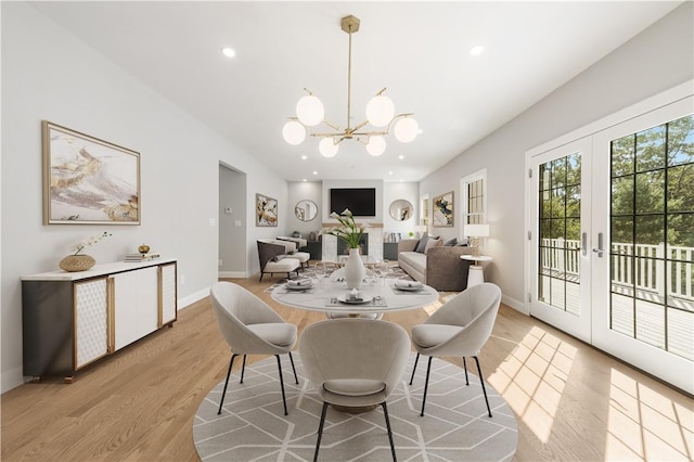 dining area with recessed lighting, baseboards, light wood finished floors, and a notable chandelier