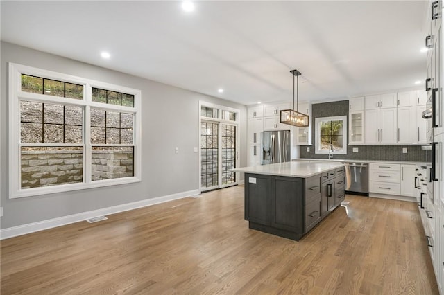 kitchen featuring white cabinets, a wealth of natural light, and stainless steel appliances