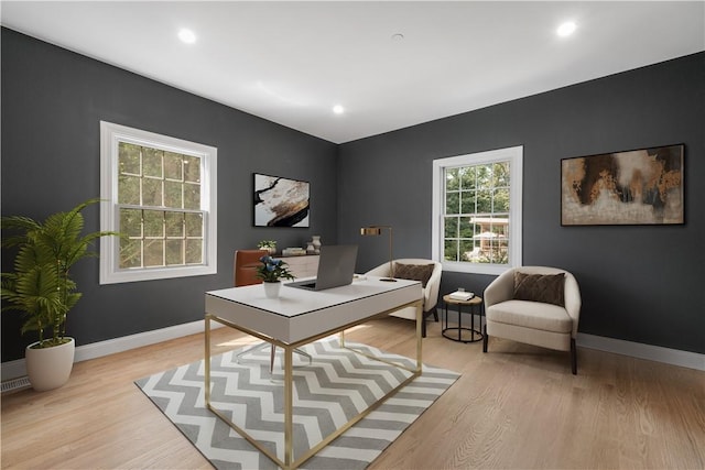 office space featuring recessed lighting, baseboards, and light wood finished floors
