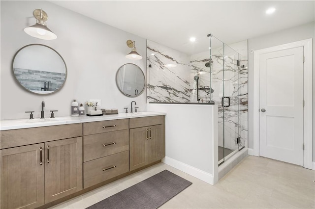 bathroom featuring a sink, a marble finish shower, recessed lighting, and double vanity