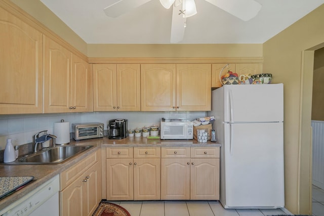 kitchen featuring a sink, light brown cabinets, white appliances, decorative backsplash, and a toaster