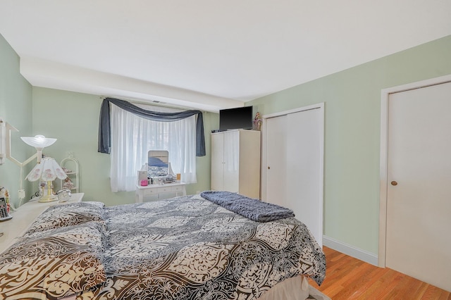 bedroom featuring wood finished floors and a closet