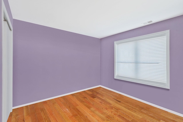 unfurnished room with baseboards, visible vents, and light wood-style flooring