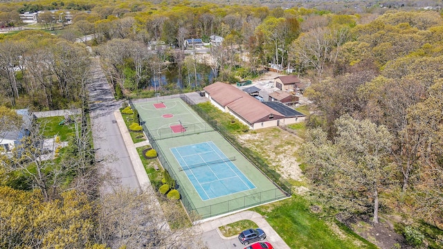 bird's eye view with a wooded view