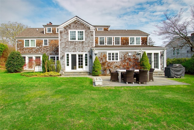 52 Northwoods Rd, Manhasset, NY 11030 - back of property featuring a patio, a yard, entry steps, and a chimney
