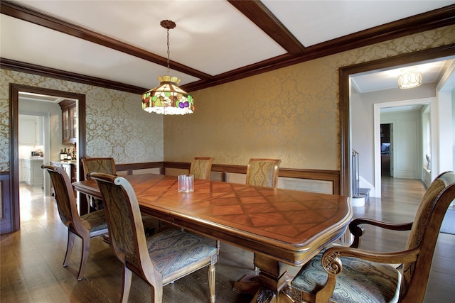 52 Northwoods Rd, Manhasset, NY 11030 - dining space featuring ornamental molding, wallpapered walls, wainscoting, and wood finished floors